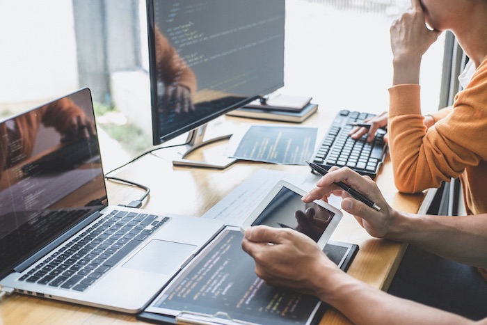 Programmers,Cooperating,At,Developing,Programming,And,Website,Working,In,A